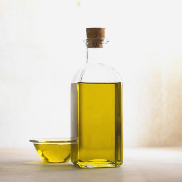 a bottle of olive oil as photographed on a phone